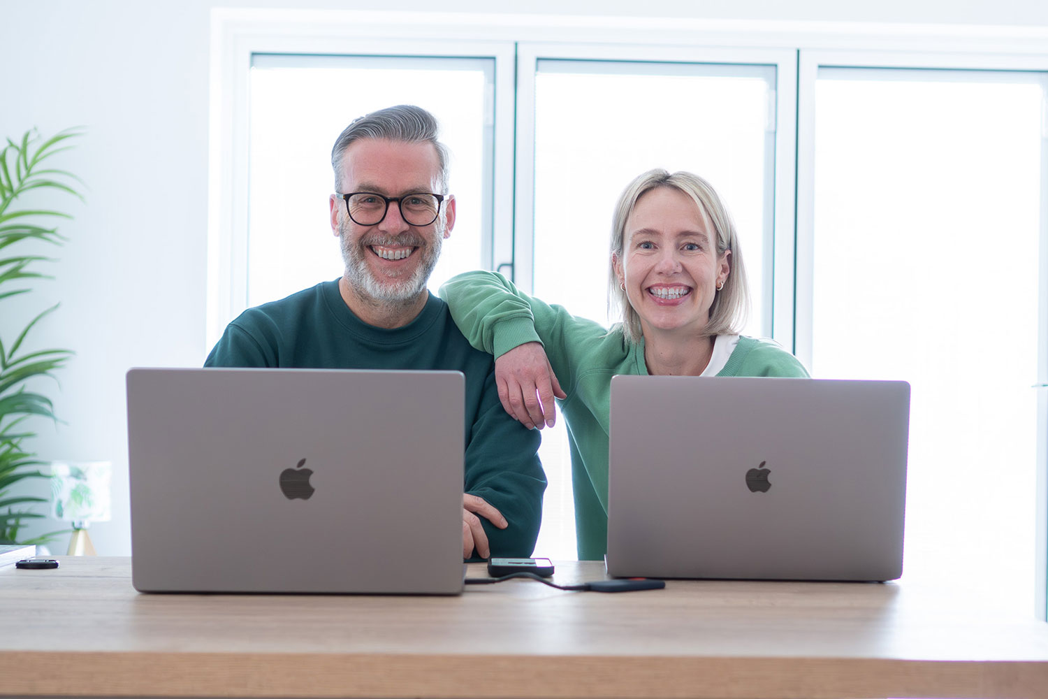 Kev and Sammy sat infront on Macbooks in the new office.